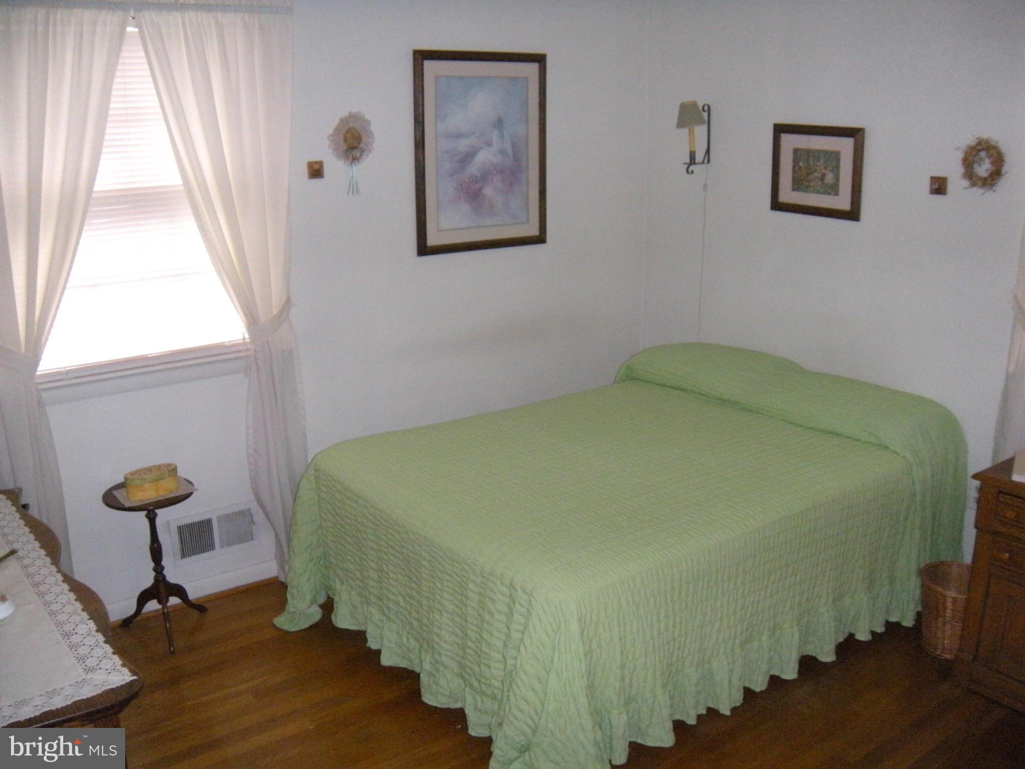 1307 Taney Avenue Frederick, MD 21702 - Photo 15 of 23 a bed sitting in a bedroom next to a window