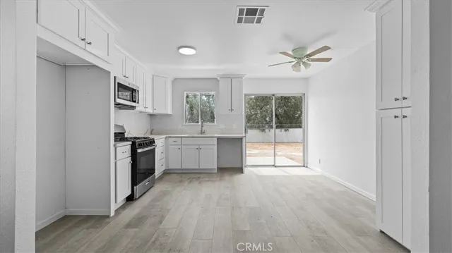 a kitchen with a stove a sink and a refrigerator