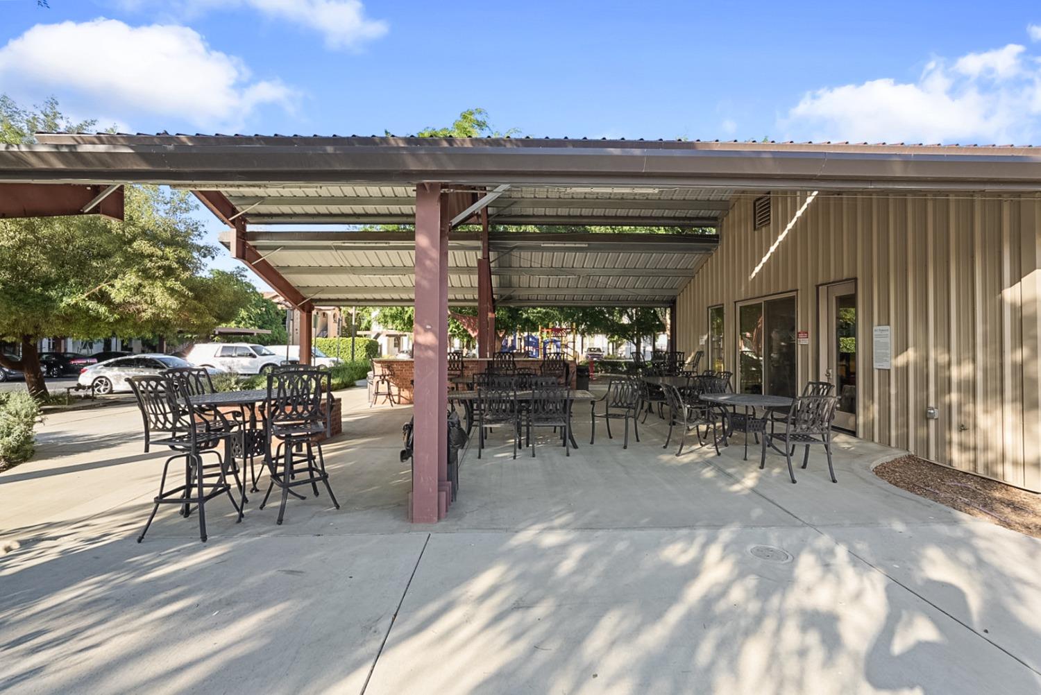 140 Ivy Avenue, Unit A5 Patterson, CA 95363 - Photo 22 of 26 a view of a tables and chairs in patio