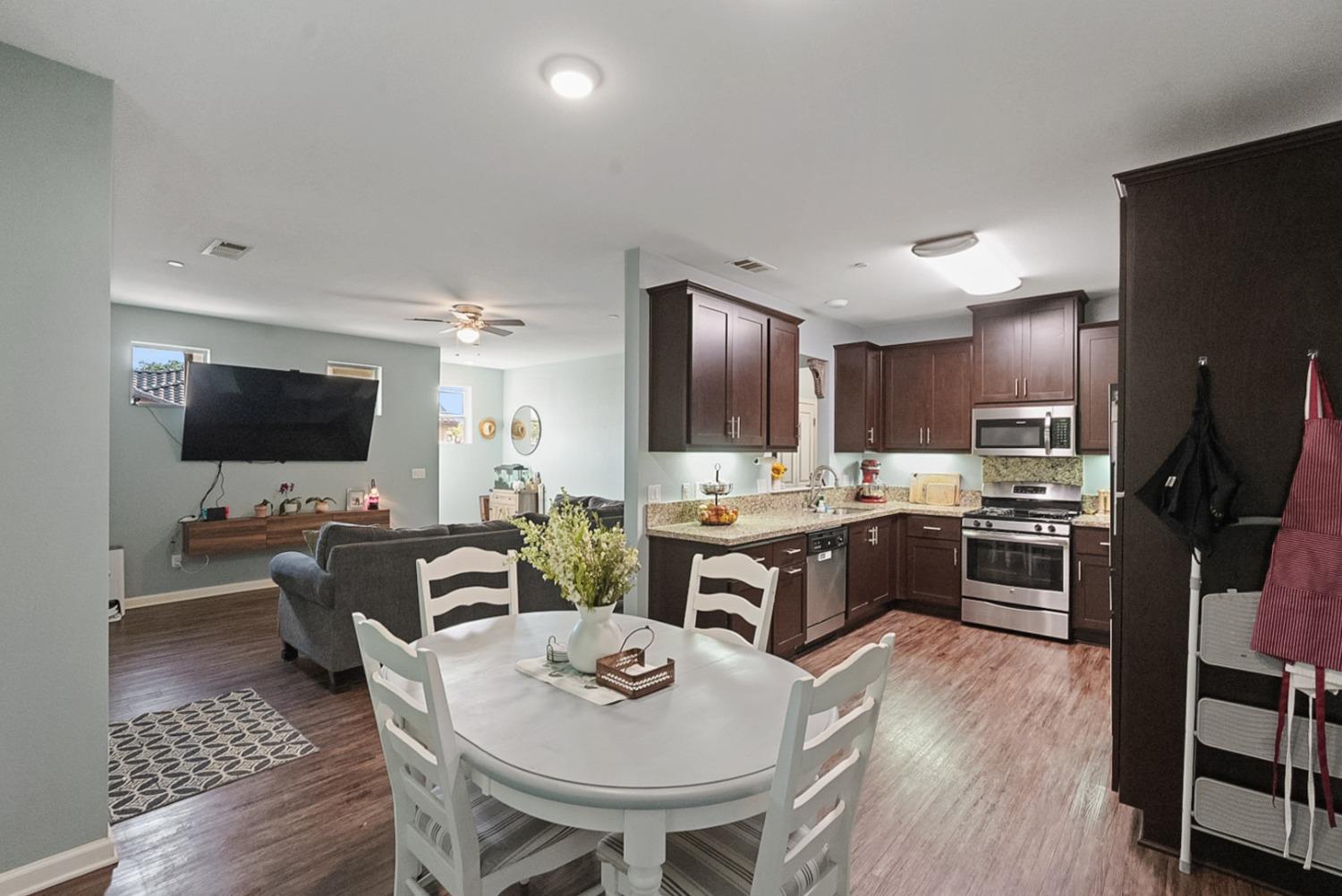 140 Ivy Avenue, Unit A5 Patterson, CA 95363 - Photo 9 of 26 a kitchen with stainless steel appliances kitchen island granite countertop a sink and cabinets