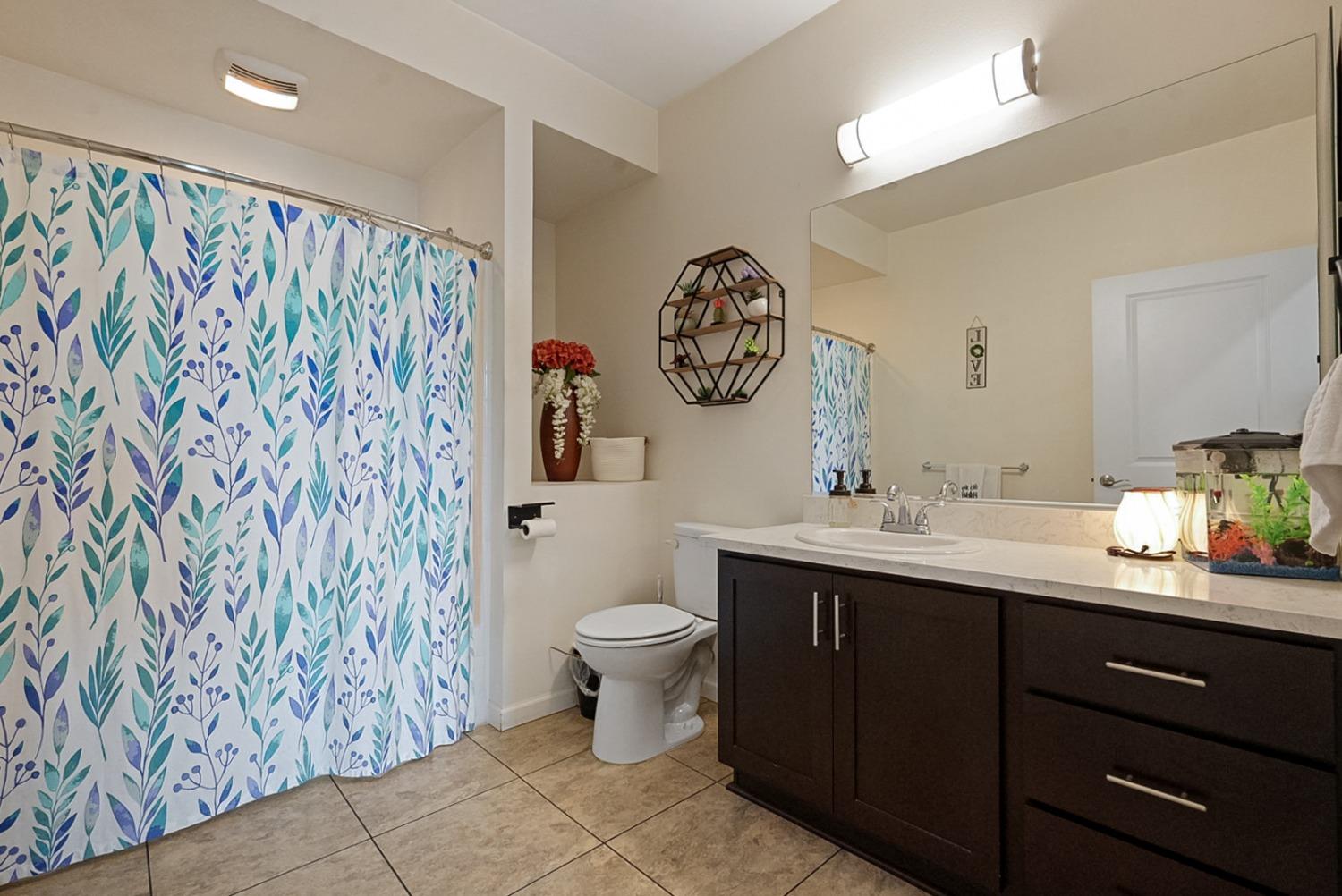 140 Ivy Avenue, Unit A5 Patterson, CA 95363 - Photo 10 of 26 a bathroom with a toilet sink and mirror