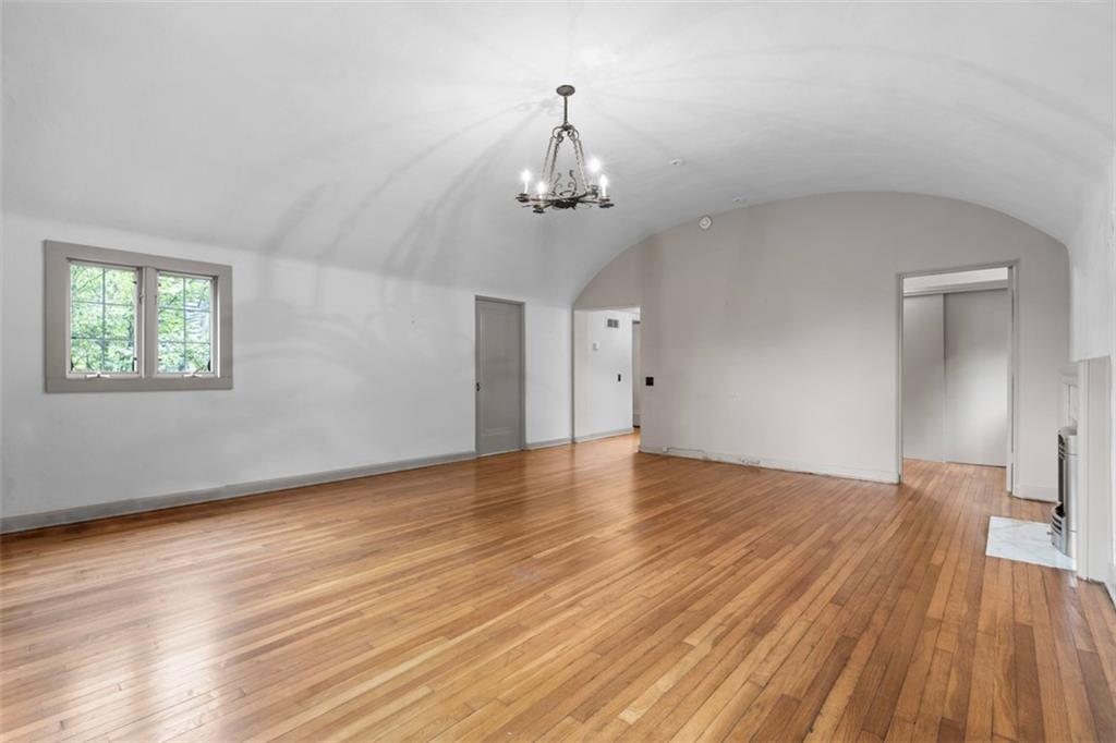 1 Robin Road Pittsburgh, PA 15217 - Photo 26 of 48 a view of a room with wooden floor staircase and a kitchen