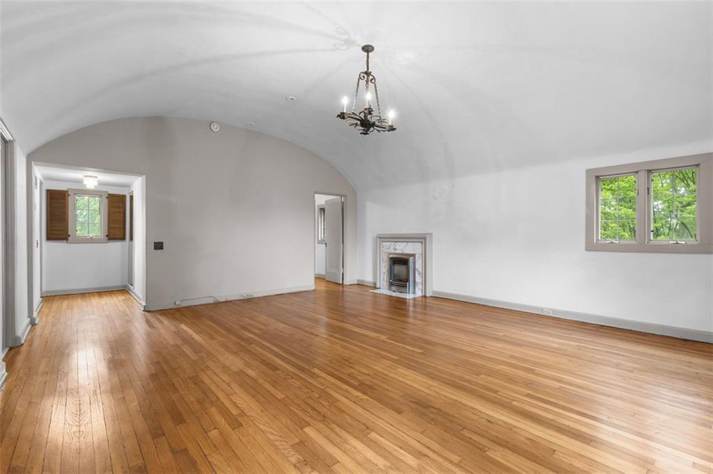 1 Robin Road Pittsburgh, PA 15217 - Photo 27 of 48 an empty room with wooden floor chandelier and windows