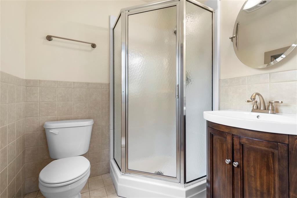 1 Robin Road Pittsburgh, PA 15217 - Photo 37 of 48 a bathroom with a toilet a sink and a mirror