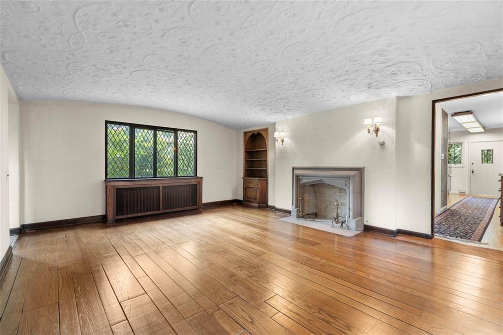 1 Robin Road Pittsburgh, PA 15217 - Photo 9 of 48 wooden floor fireplace and windows in an empty room