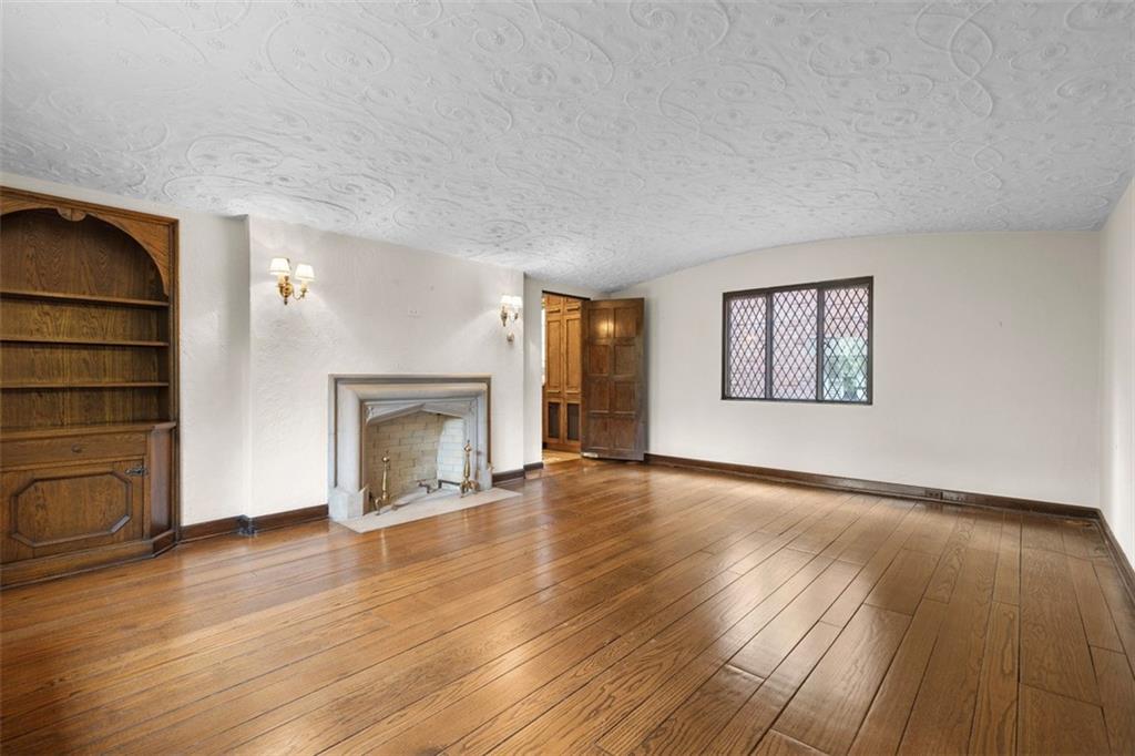1 Robin Road Pittsburgh, PA 15217 - Photo 10 of 48 an empty room with wooden floor fireplace and windows