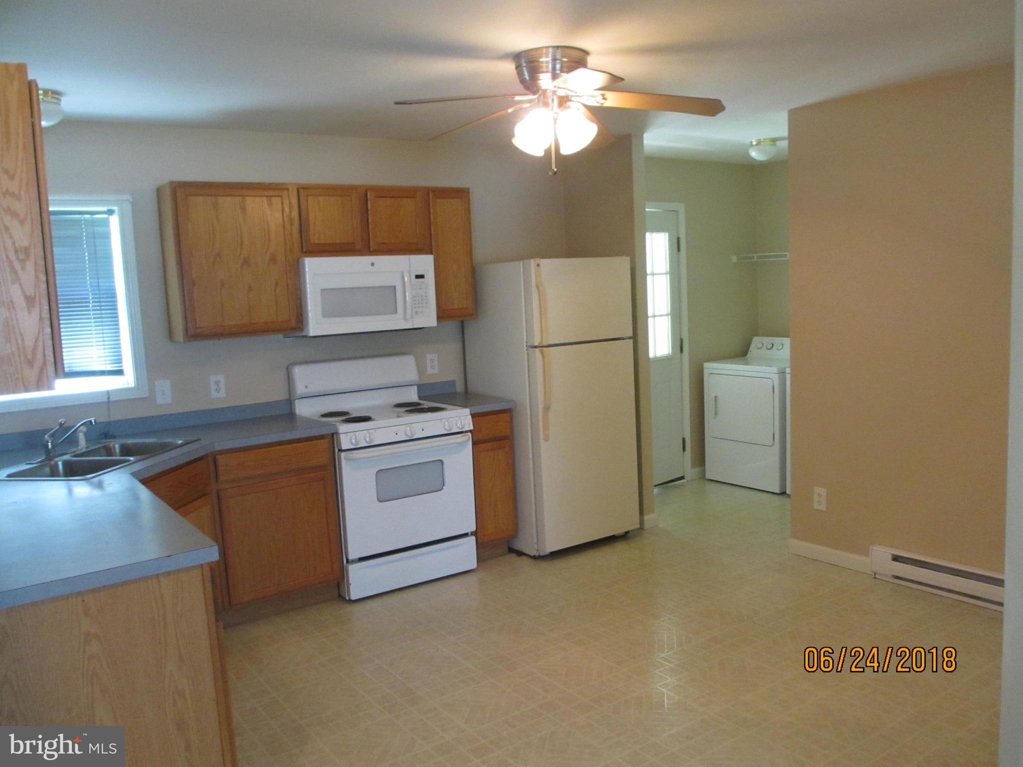 5732 Allender Road White Marsh, MD 21162 - Photo 2 of 15 a kitchen with stainless steel appliances white cabinets and a refrigerator