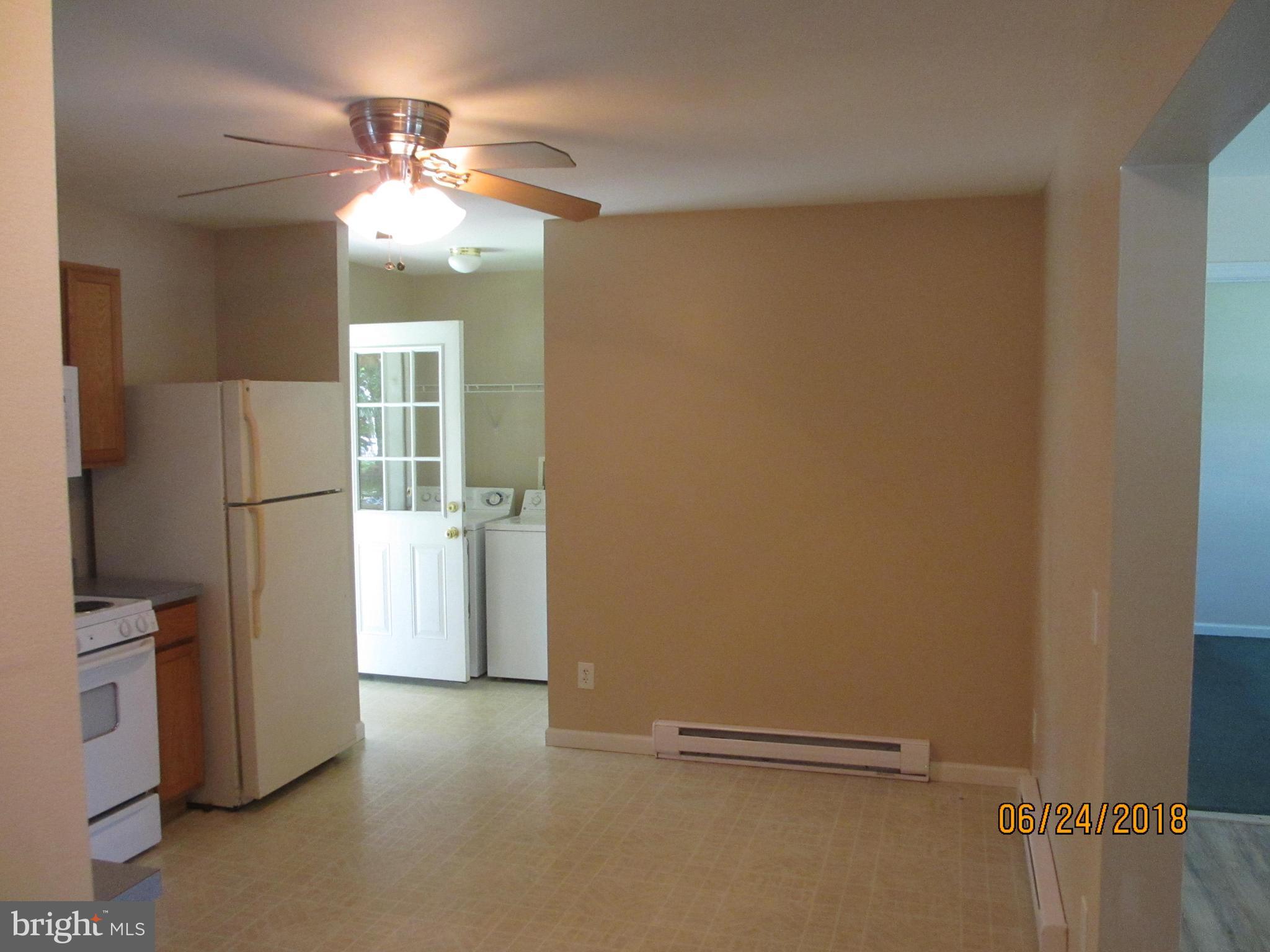 5732 Allender Road White Marsh, MD 21162 - Photo 4 of 15 a view of a livingroom with a refrigerator a fireplace and a chandelier fan