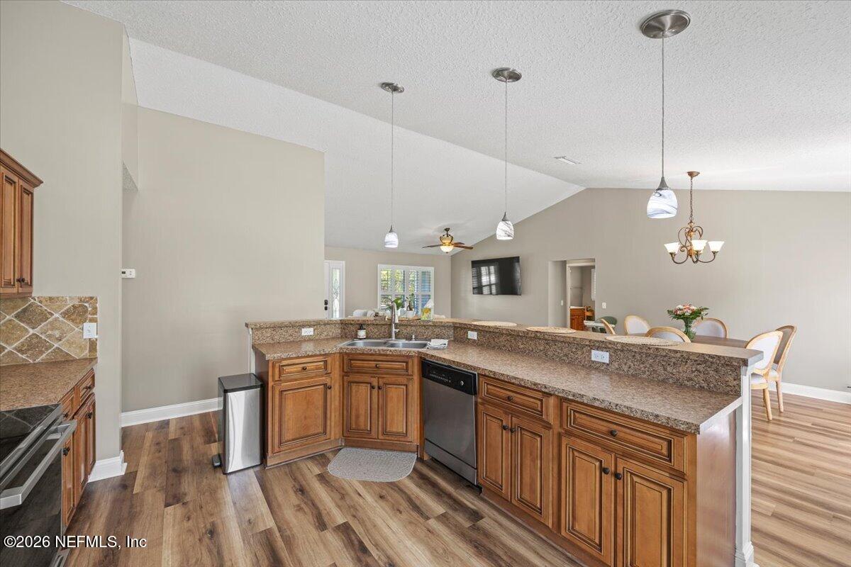 54130 Church Road Callahan, FL 32011 - Photo 13 of 42 a kitchen with a sink a stove and chairs