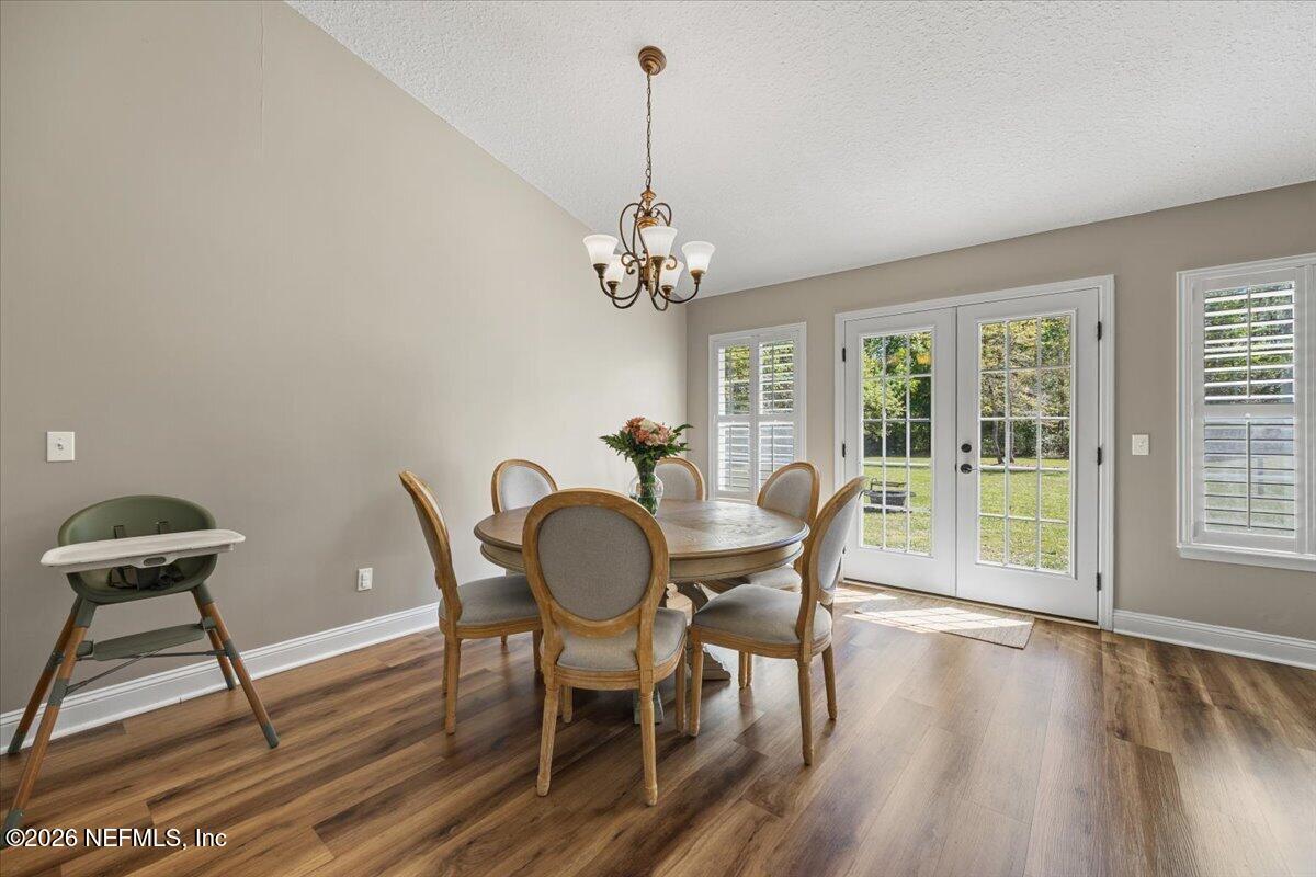 54130 Church Road Callahan, FL 32011 - Photo 18 of 42 a dining room with furniture a chandelier and wooden floor