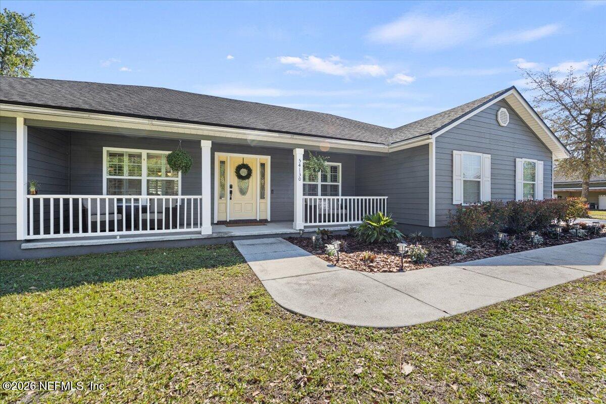 54130 Church Road Callahan, FL 32011 - Photo 2 of 42 a view of a house with a porch