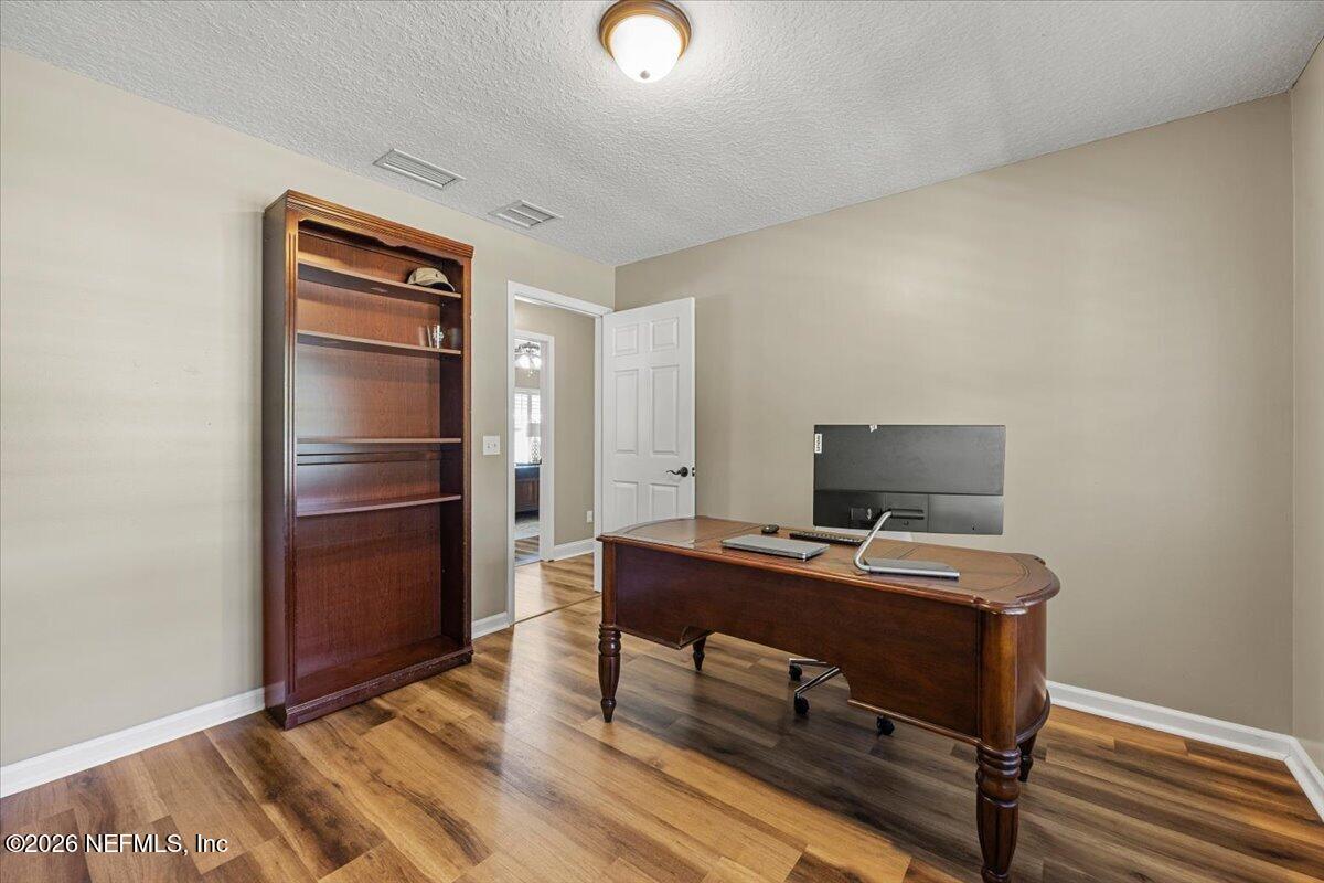 54130 Church Road Callahan, FL 32011 - Photo 21 of 42 a view of a workspace with furniture and wooden floor