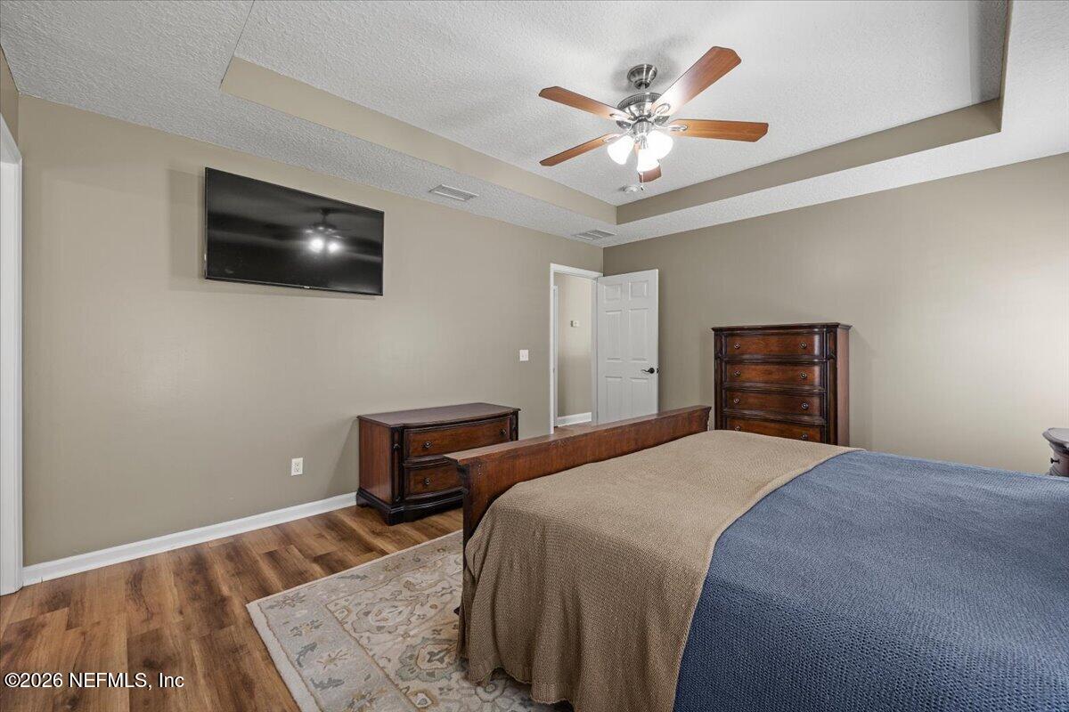 54130 Church Road Callahan, FL 32011 - Photo 24 of 42 a bedroom with a bed and a flat screen tv