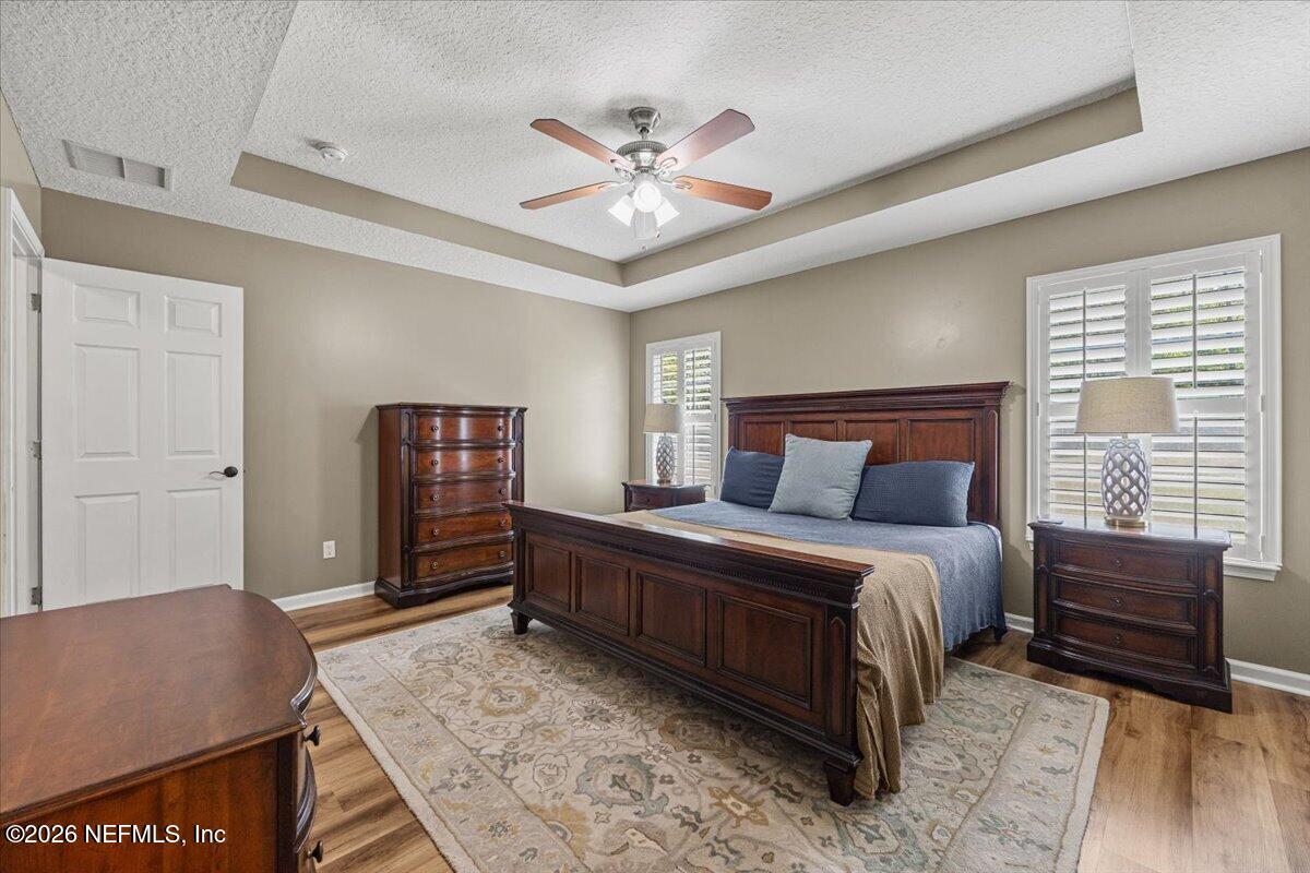 54130 Church Road Callahan, FL 32011 - Photo 25 of 42 a bedroom with a bed and a dresser with wooden floor