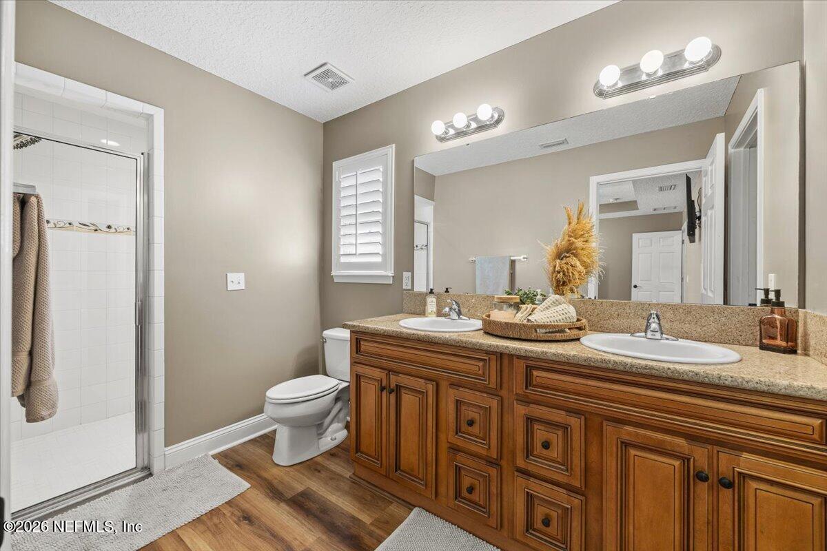54130 Church Road Callahan, FL 32011 - Photo 26 of 42 a bathroom with a toilet sink and mirror