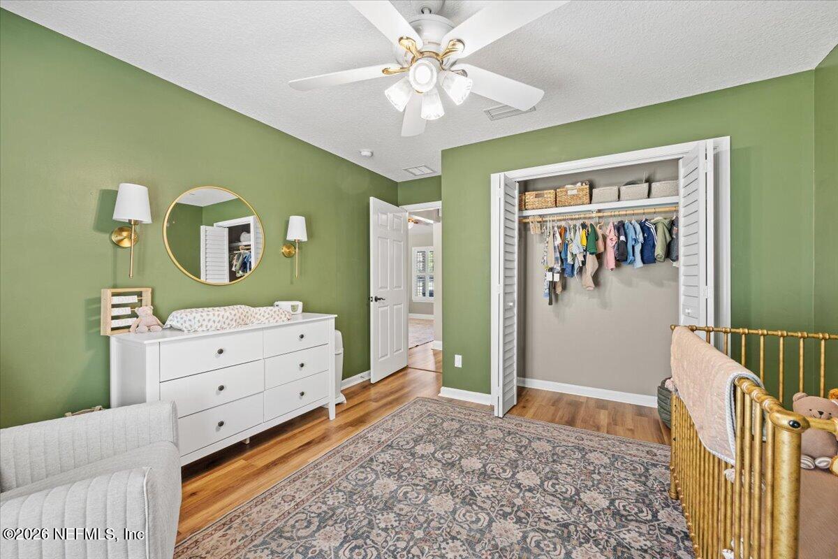 54130 Church Road Callahan, FL 32011 - Photo 30 of 42 a bedroom with a baby bed and a dresser