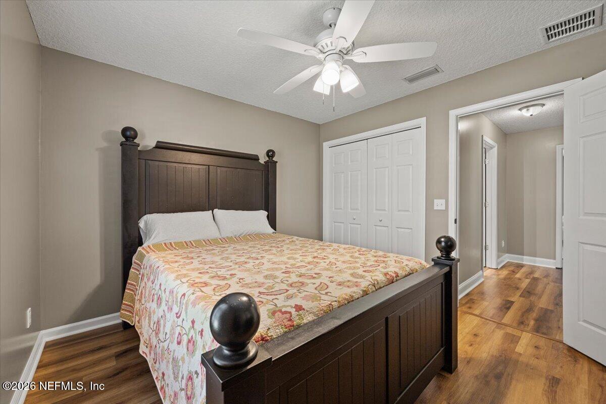 54130 Church Road Callahan, FL 32011 - Photo 33 of 42 a bedroom with a bed and a chandelier