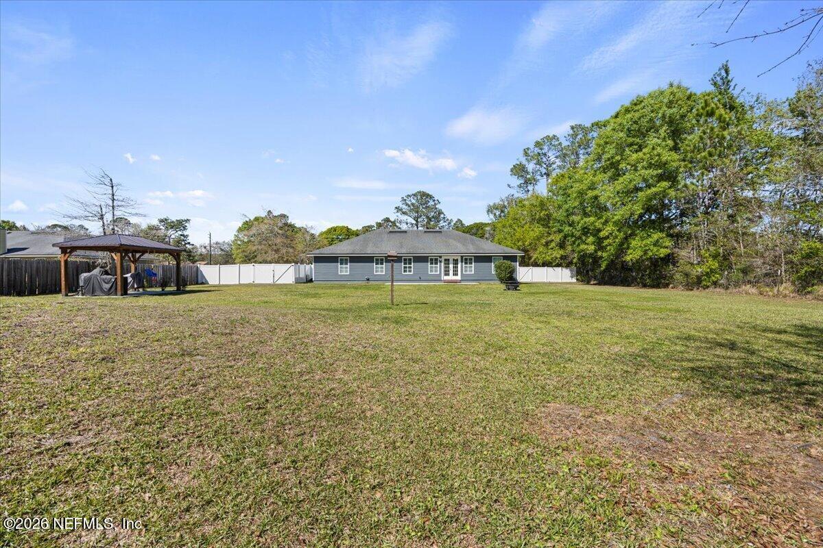 54130 Church Road Callahan, FL 32011 - Photo 40 of 42 a front view of a house with garden