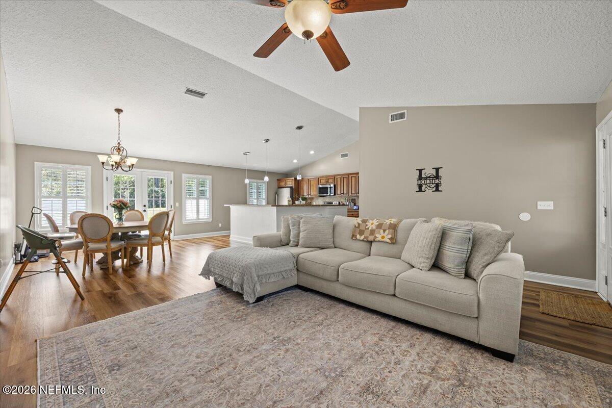 54130 Church Road Callahan, FL 32011 - Photo 8 of 42 a living room with furniture and a chandelier