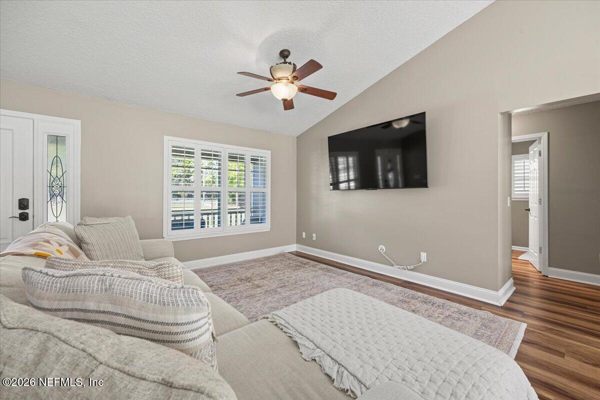 54130 Church Road Callahan, FL 32011 - Photo 10 of 42 a bedroom with a bed couches and flat screen tv