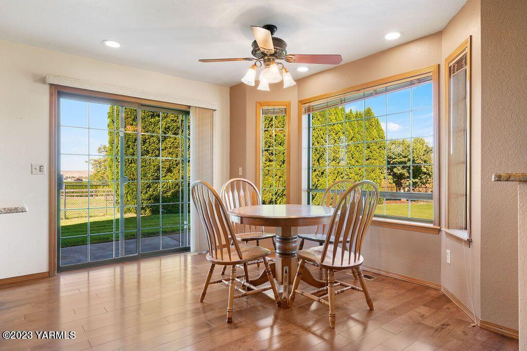 1703 Stein Road Yakima, WA 98908 - Photo 13 of 41 a view of a dining room with furniture large windows and wooden floor