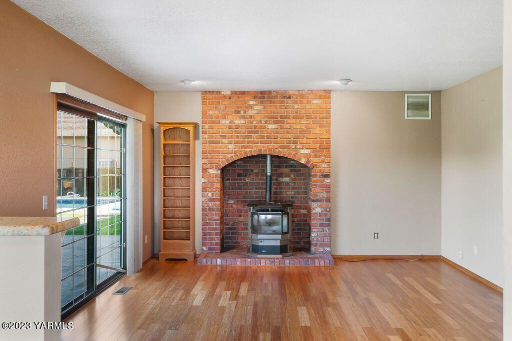 1703 Stein Road Yakima, WA 98908 - Photo 14 of 41 a view of empty room with wooden floor and fireplace