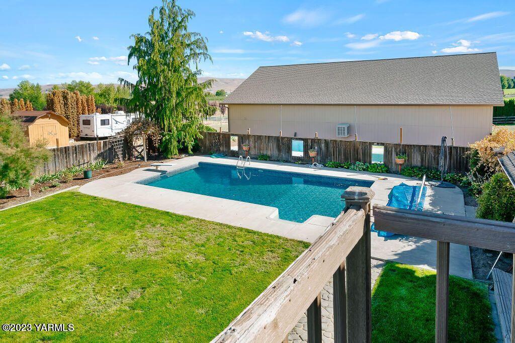 1703 Stein Road Yakima, WA 98908 - Photo 24 of 41 a view of a house with pool and chairs