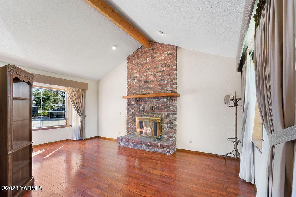 1703 Stein Road Yakima, WA 98908 - Photo 5 of 41 a view of an empty room with a window and wooden floor