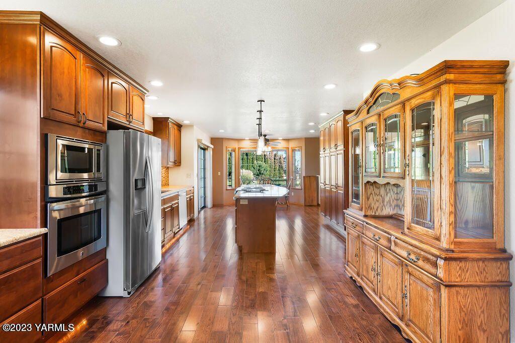 1703 Stein Road Yakima, WA 98908 - Photo 8 of 41 a view of a kitchen with a large window and wooden floor