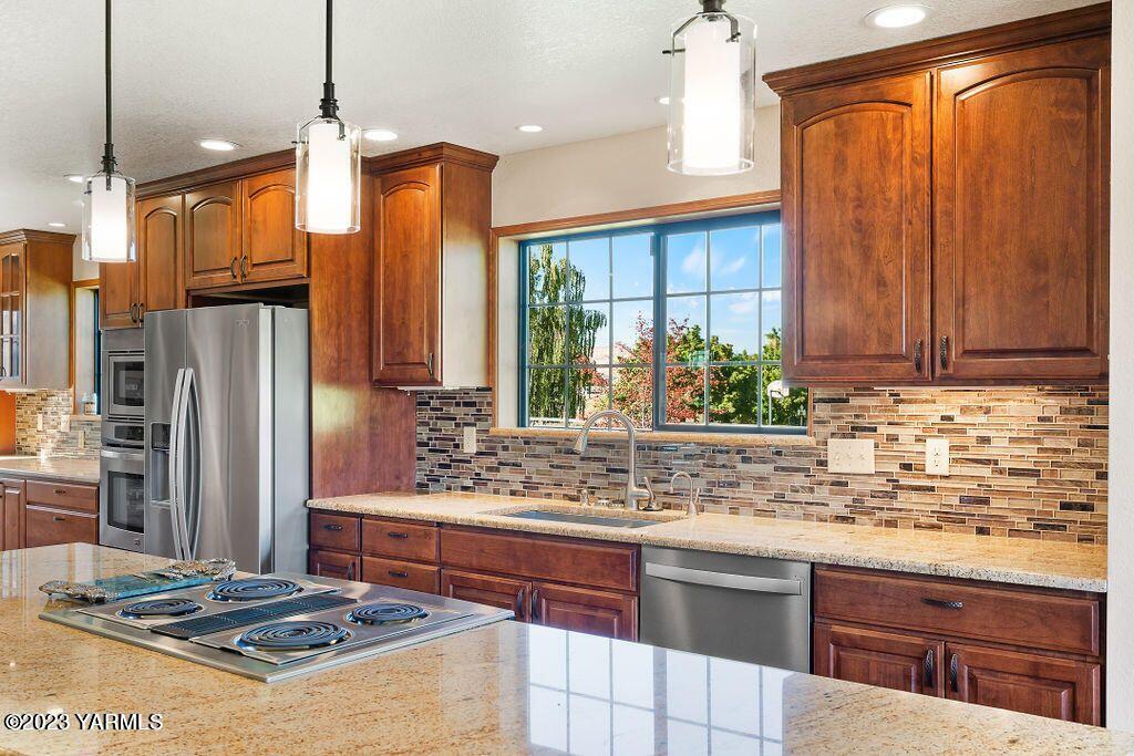 1703 Stein Road Yakima, WA 98908 - Photo 10 of 41 a kitchen with stainless steel appliances granite countertop a stove refrigerator and cabinets