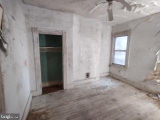 1915 Edmondson Avenue Baltimore, MD 21223 - Photo 3 of 7 an empty room with windows and closet