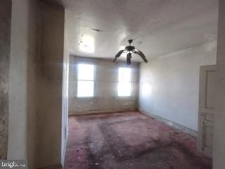 1915 Edmondson Avenue Baltimore, MD 21223 - Photo 4 of 7 a view of empty room with a ceiling fan and window