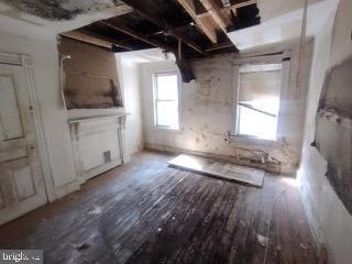 1915 Edmondson Avenue Baltimore, MD 21223 - Photo 6 of 7 a view of empty room with wooden floor and fan