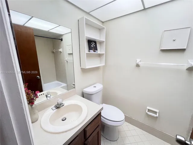 a bathroom with a sink toilet and mirror