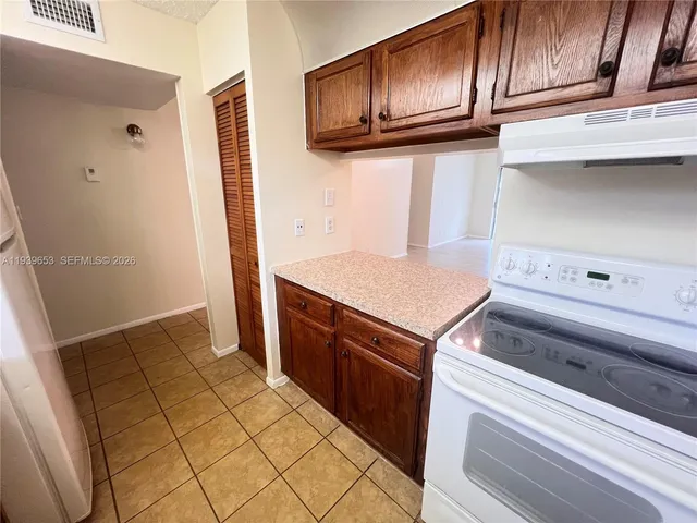 a kitchen with granite countertop cabinets and steel appliances