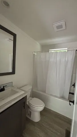 a bathroom with a toilet a sink and a mirror