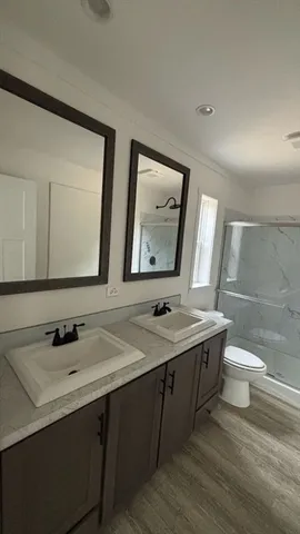 a bathroom with a double vanity sink and a mirror