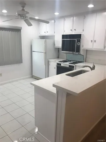 a kitchen with a sink and a stove top oven