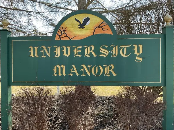 a sign broad on a brick wall