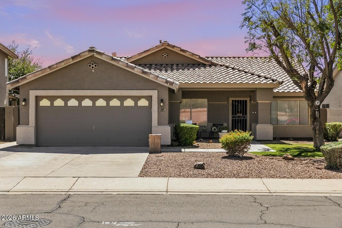 49 West Ivanhoe Street Gilbert, AZ 85233 - Photo 1 of 54 a front view of a house with a yard and garage