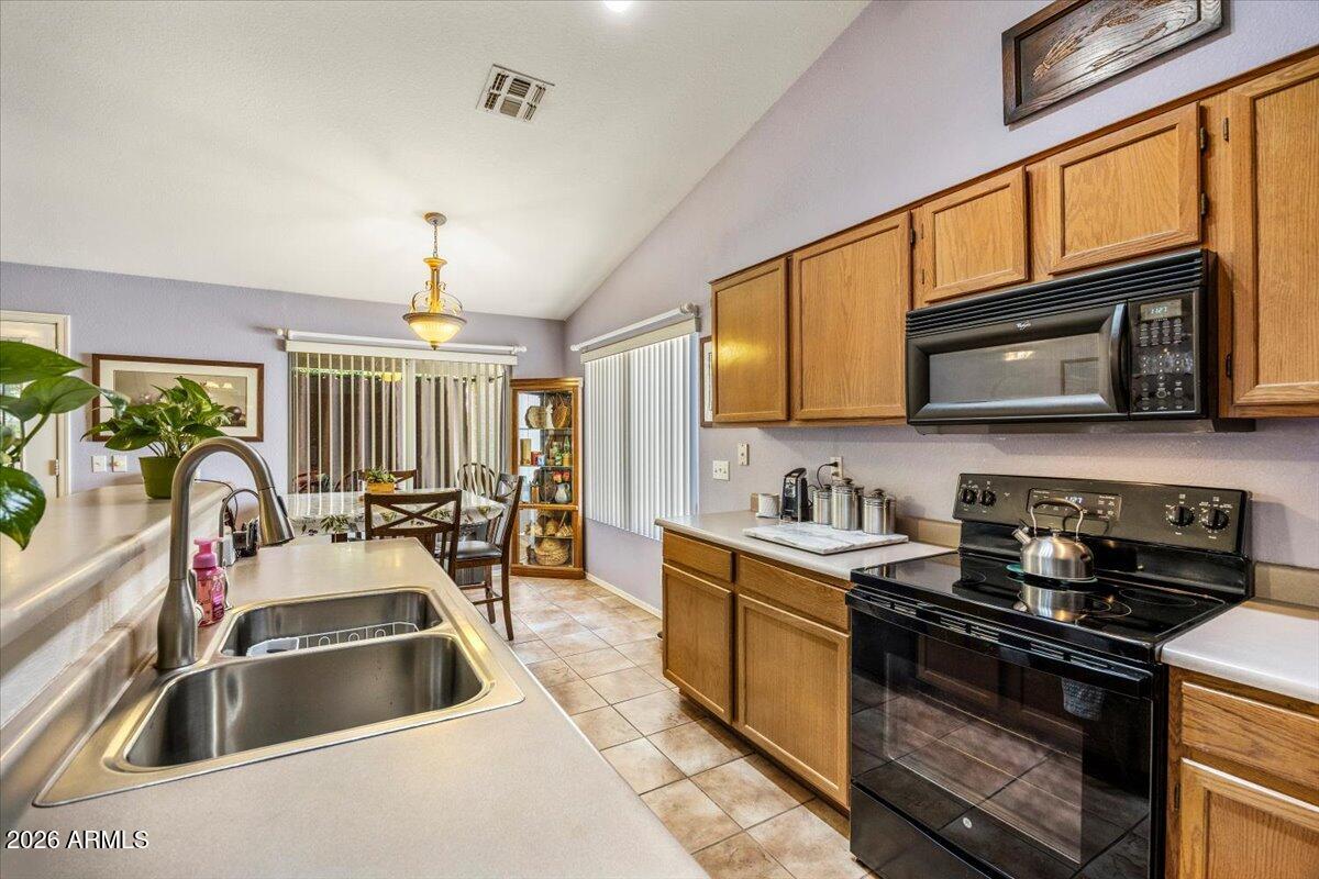 49 West Ivanhoe Street Gilbert, AZ 85233 - Photo 12 of 54 a kitchen with stainless steel appliances a stove sink microwave and cabinets