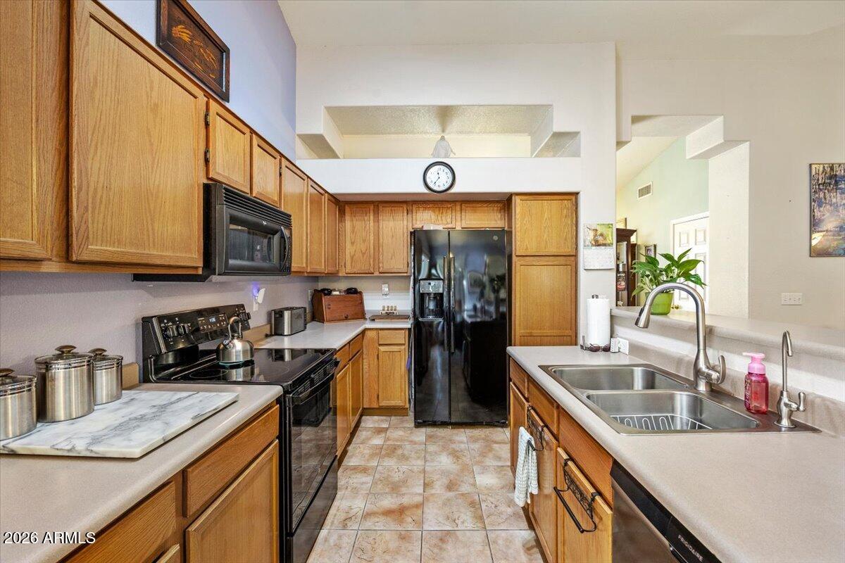 49 West Ivanhoe Street Gilbert, AZ 85233 - Photo 14 of 54 a kitchen with stainless steel appliances granite countertop a sink a stove and a refrigerator