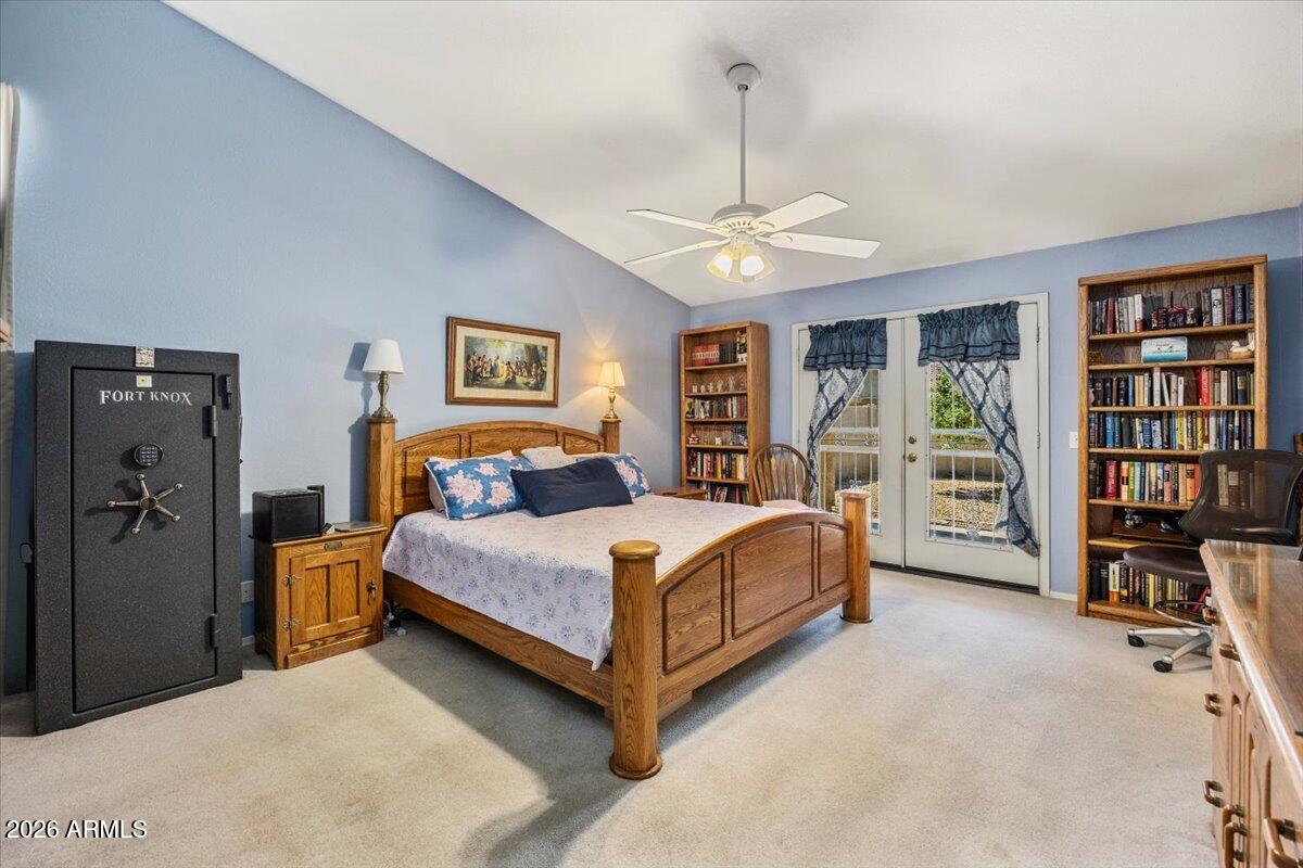 49 West Ivanhoe Street Gilbert, AZ 85233 - Photo 20 of 54 a bedroom with a large bed and a chandelier