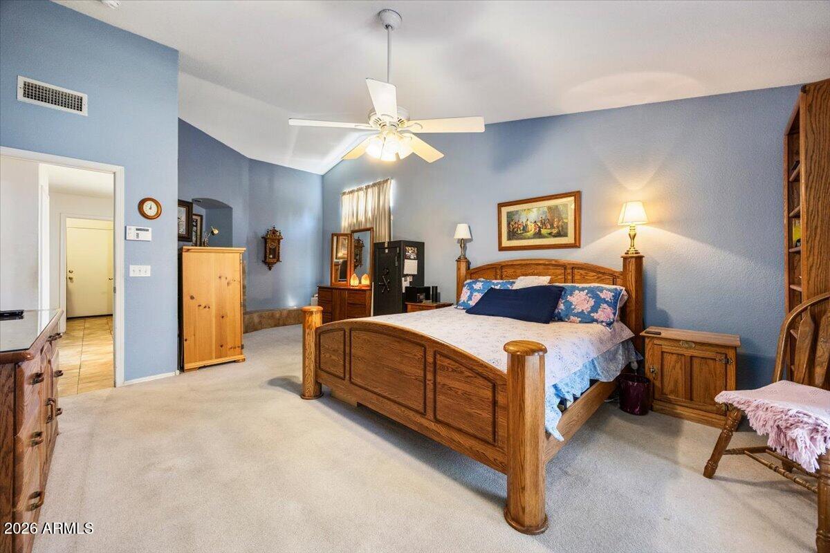 49 West Ivanhoe Street Gilbert, AZ 85233 - Photo 21 of 54 a spacious bedroom with a bed and a chandelier