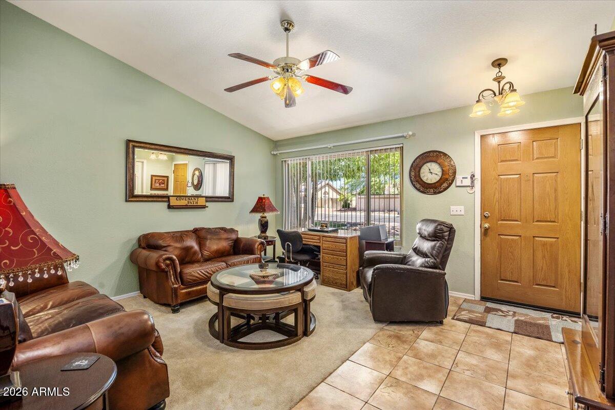 49 West Ivanhoe Street Gilbert, AZ 85233 - Photo 9 of 54 a living room with furniture a window and a clock