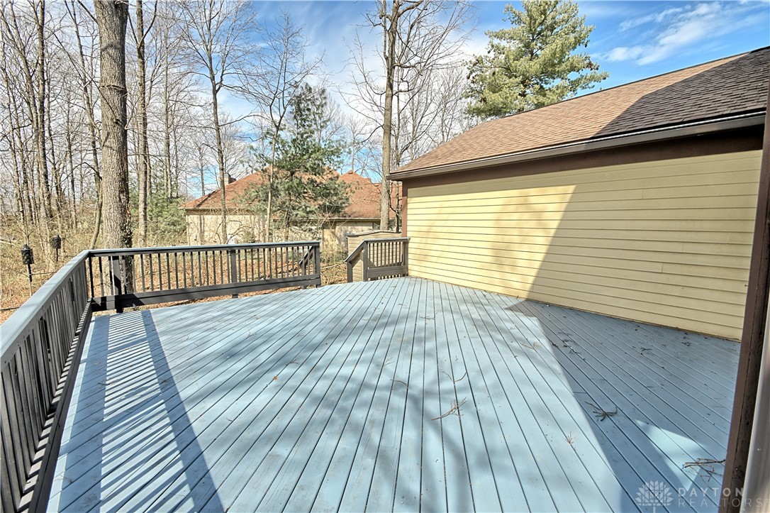 8711 Nicole Lane Springboro, OH 45066 - Photo 76 of 87 This spacious wooden deck offers an ideal setting for outdoor enjoyment amidst a serene wooded backdrop.