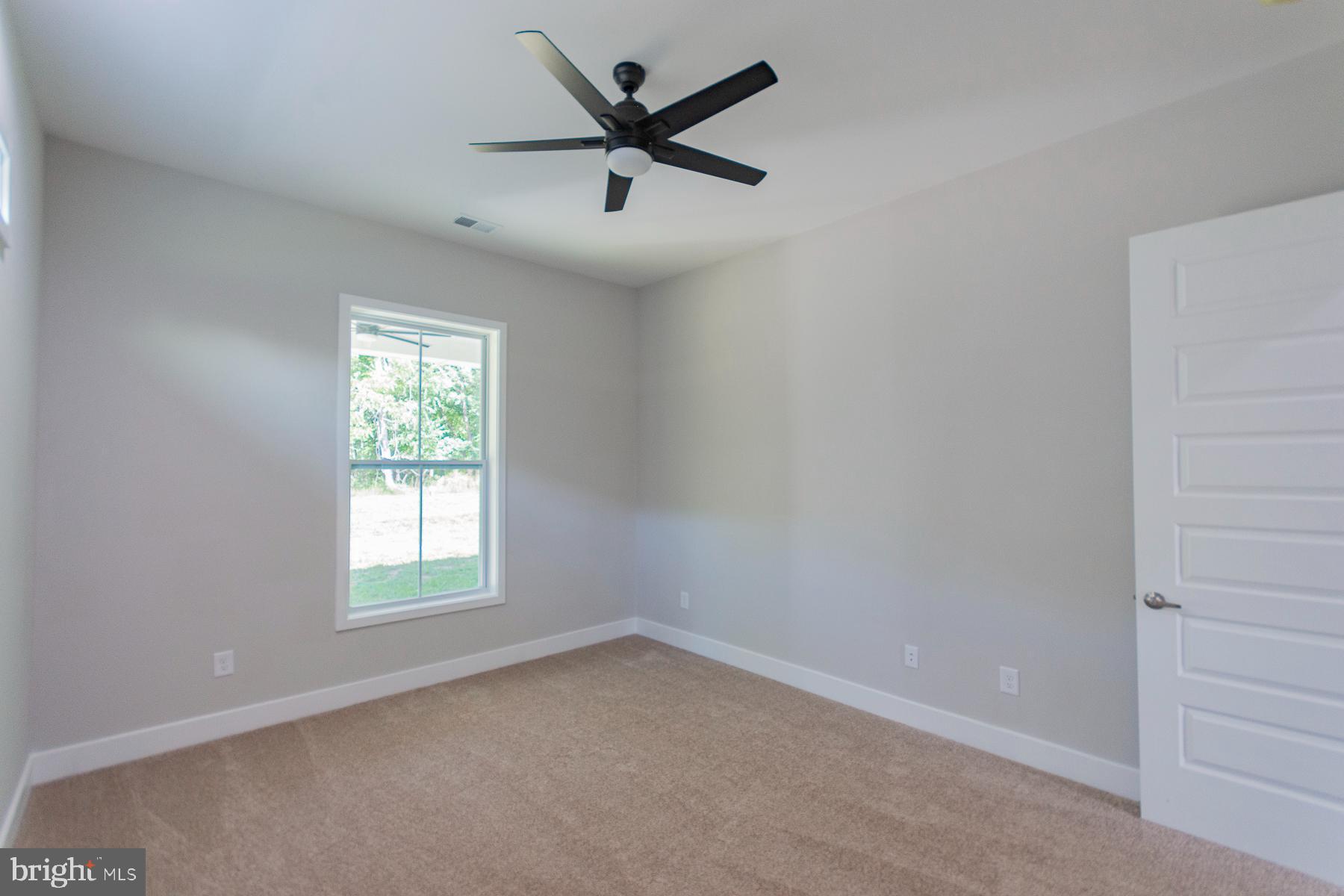 85 Glenaire Road Bunker Hill, WV 25413 - Photo 41 of 68 an empty room with a window and a fan