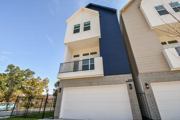 a front view of a house with a tree