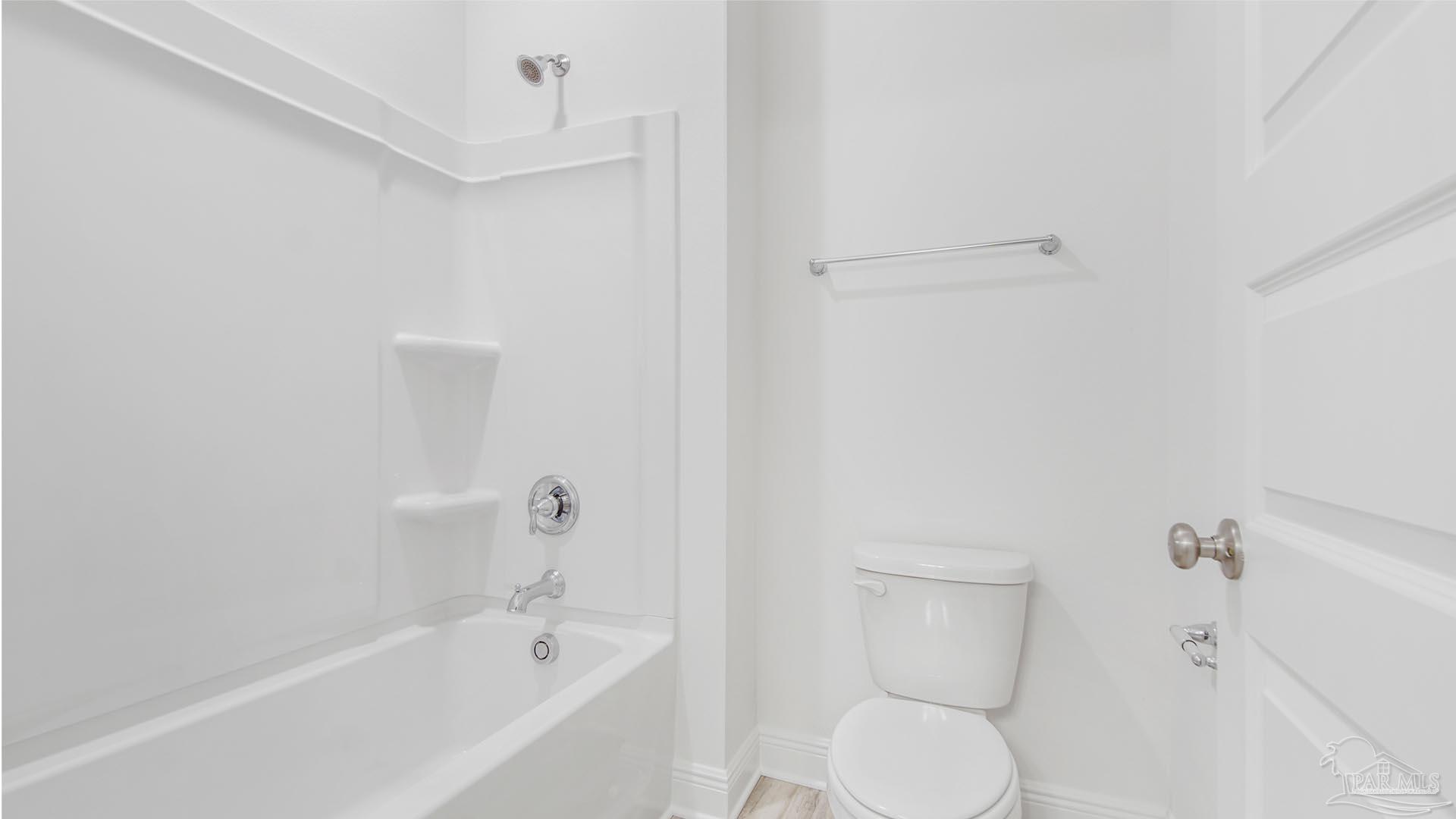 3233 Harrier Road Pace, FL 32571 - Photo 22 of 50 a white toilet sitting next to a bath tub