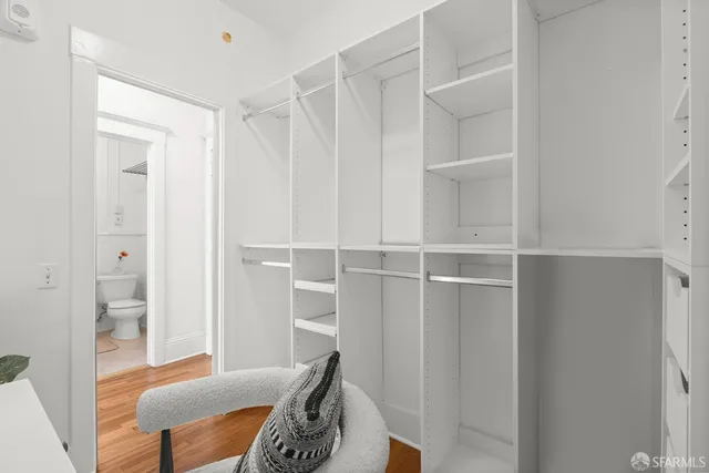 a livingroom with wooden floor and a bathroom